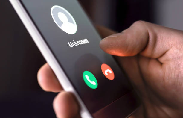 Phone call from unknown number late at night. Scam, fraud or phishing with smartphone concept. Prank caller, scammer or stranger. Man answering to incoming call. Phone call from unknown number late at night. Scam, fraud or phishing with smartphone concept. Prank caller, scammer or stranger. Man answering to incoming call. Hoax person with fake identity. harassment stock pictures, royalty-free photos & images
