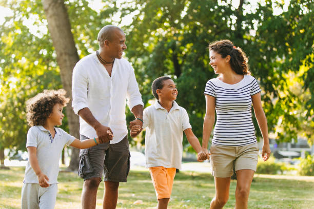 istock Happy couple spending time with their sons in the park 1158779227