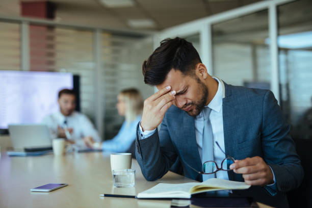 istock Young overworked businessman in the office 1158779325