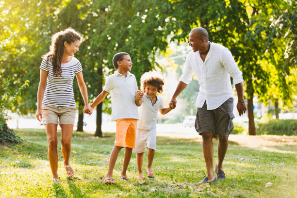 istock Happy couple spending time with their sons in the park 1158779418