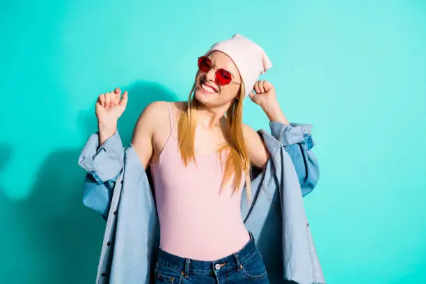 Portrait of her she nice-looking attractive lovely fascinating cool cheerful, cheery girl wearing streetstyle clothing having fun time isolated on bright vivid shine blue green turquoise background