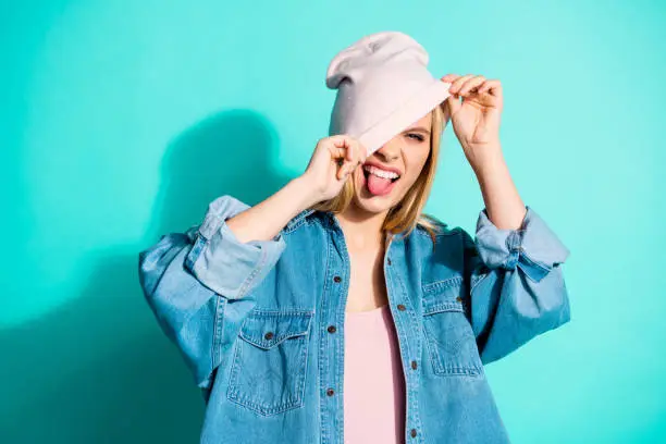 Close-up portrait of nice attractive lovely charming cheerful cheery crazy teen girl wearing modern, cool streetstyle clothing accessory isolated over bright vivid shine blue green turquoise background