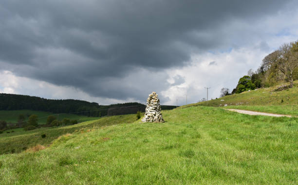 istock Storm Clouds Over a White Cairn Trail Marker 1158781753