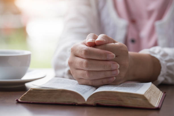 istock Women reading the Holy Bible,Reading a book. 1158781872