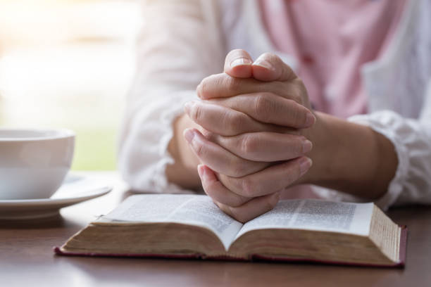 istock Women reading the Holy Bible,Reading a book. 1158781873