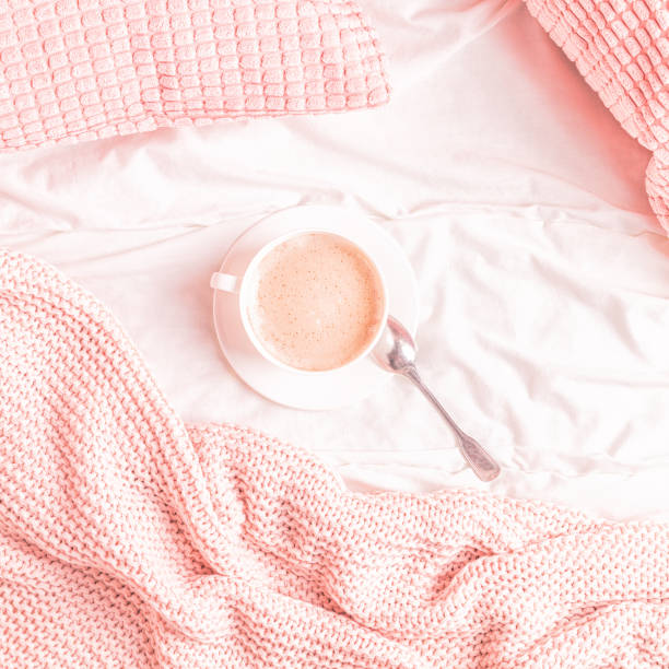 istock Bed with pink knitted plaid and coffee 1158782238