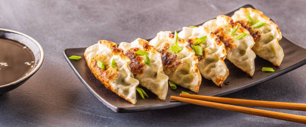 istock Gyoza or dumplings snack with soy sauce, selective focus 1158782242