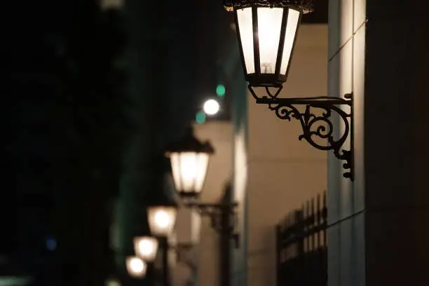 Night view of many streetlights attached to the wall