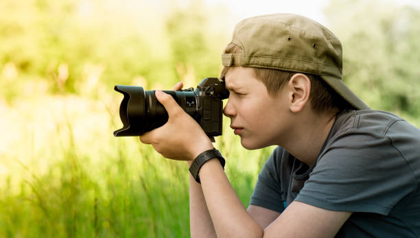istock Young photographer shooting nature with SLR camera 1158783507