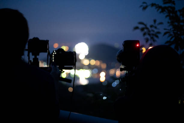istock Photographer shooting fireworks at fireworks display 1158783770