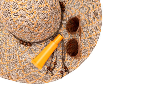 istock Yellow sunglasses, striped hat and sunscreen. Summer concept on white background. 1158783819
