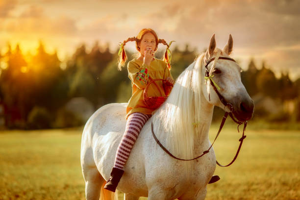 Red haired cute girl with grey horse in Pippi Longstocking style