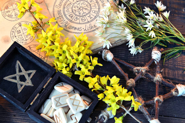 istock Box with runes, pentagram and flowers on green witch table. 1158786249