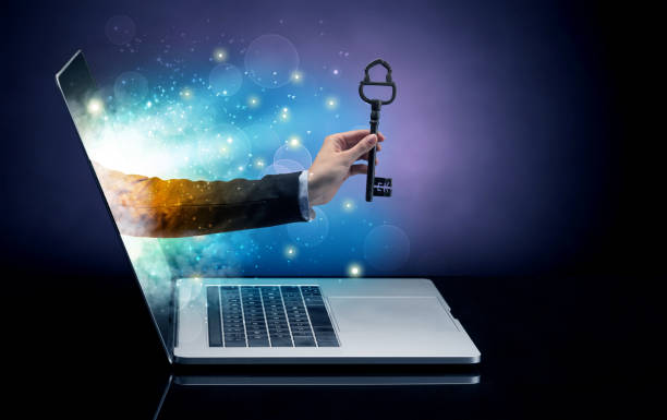 istock Hand with key coming out of a laptop 1158787084