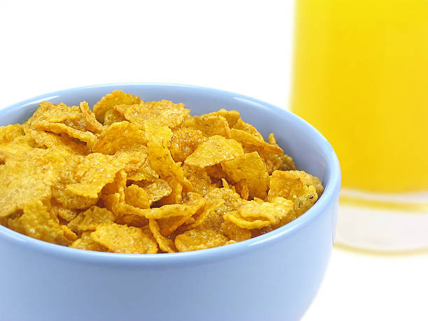 Bowl of cereal and orange juice stock photo