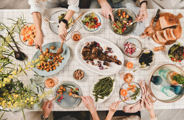 istock Peoples hands over table with meat, salads, rose wine 1158789608