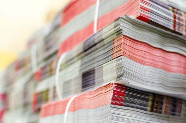 Pile of bundled magazines in offset print plant delivery department, selective focus background stock photo