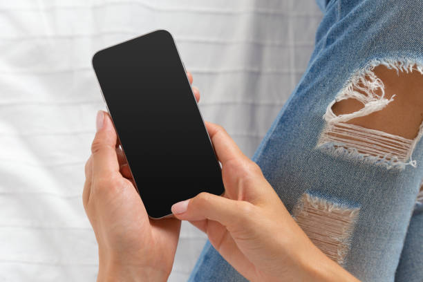 istock Woman checking the cell phone on the bed 1158792477