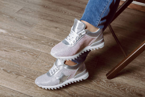 istock woman legs in sneakers 1158792759