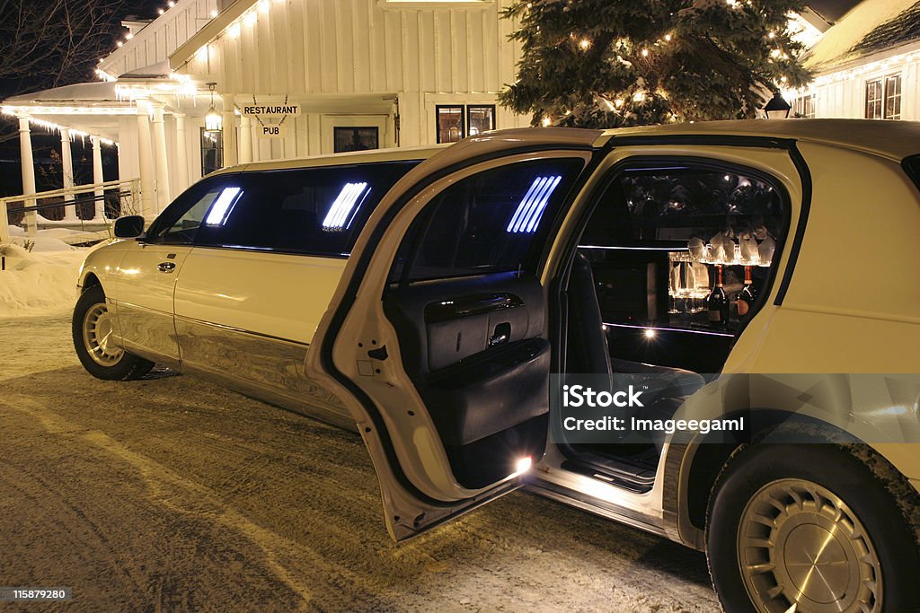 Your limo is waiting Your limo is waiting - Don't drink and drive - Bottles of bubbly visible inside the limo - Restaurant and Pub signs visible in the background. Limousine Stock Photo