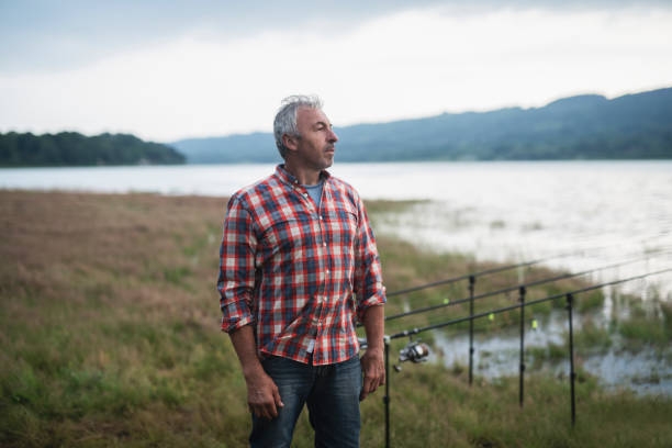 istock Senior fisherman relaxing on lake. 1158792901