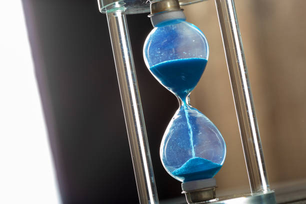 istock Time is passing. Blue hourglass close up 1158792946