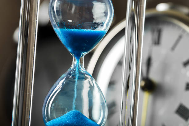 istock Time is passing. Blue hourglass close up 1158794097