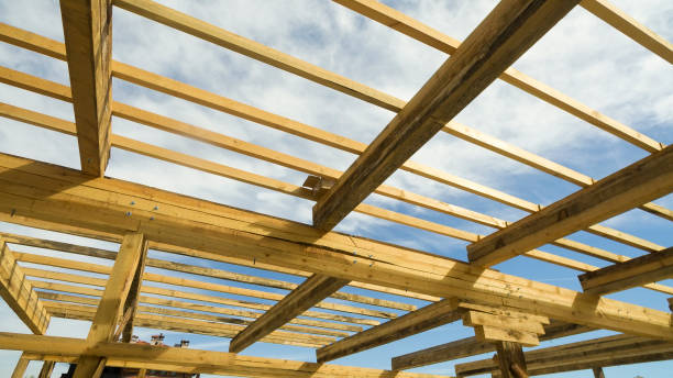 istock New residential construction home framing against a blue sky and sun 1158794500