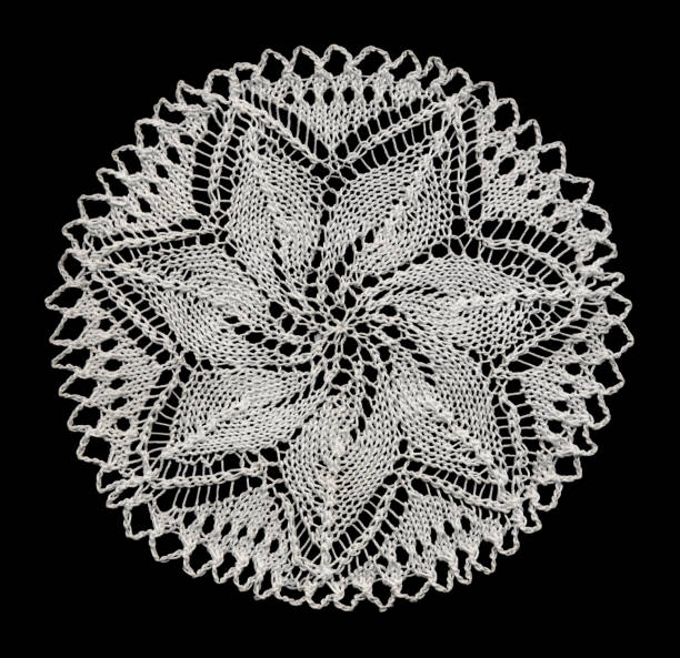 knitted lace doily Knitted doily with star pattern. doily stock pictures, royalty-free photos & images