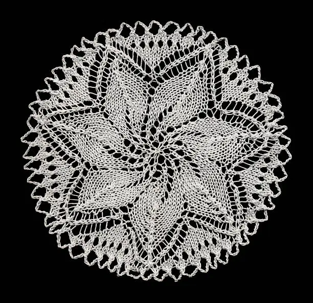 Knitted doily with star pattern.