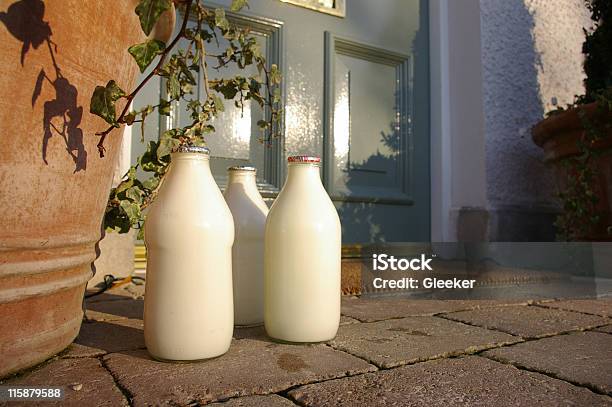 Three Jugs Of Fresh Milk Sitting At The Front Doorstep Stock Photo - Download Image Now