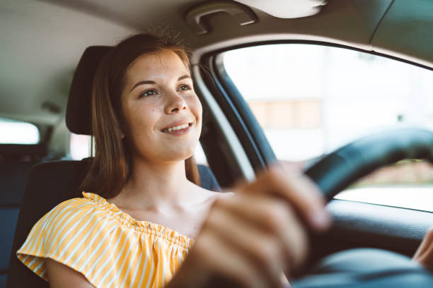 istock Smiling woman driver looking on the road 1158796200