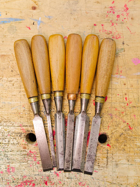istock Group of assorted woodworking chisels isolated on wooden bench grunge surface. 1158796867