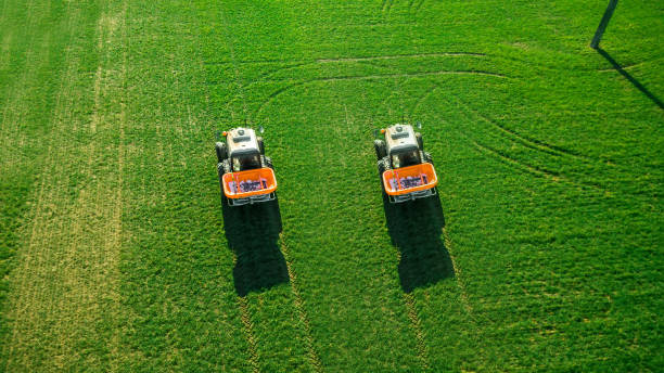 istock tractor makes fertilizer on the field. Aerial survey 1158797090