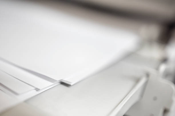 istock Laser Jet Digital Printer Printing paper with dof blur copyspace, focus on paper corner 1158798287
