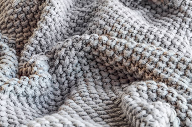 istock Abstract of a soft knit grey throw blanket 1158798290