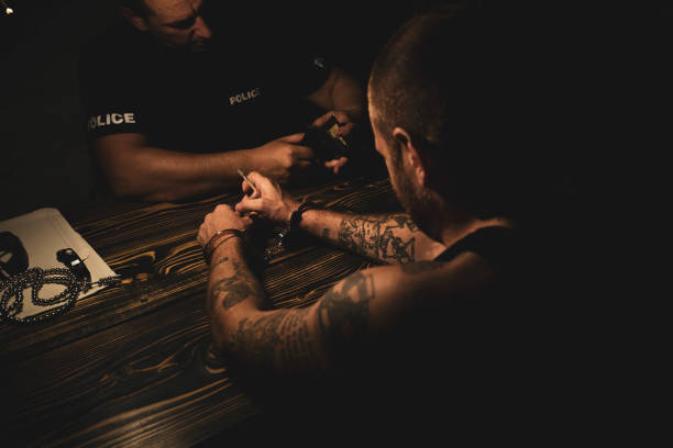 Pointing to the criminal Prisoner and detective in the police station drug addiction tattoos stock pictures, royalty-free photos & images