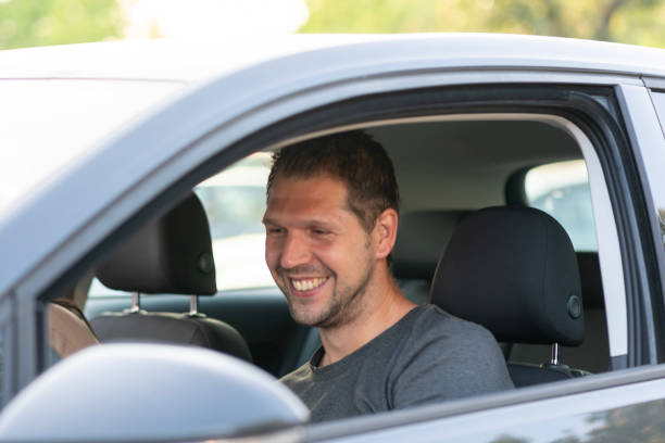 istock Young happy german man smiling in the car 1158802331