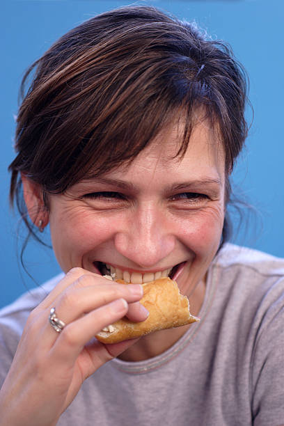 istock woman eating cream cake 115880465
