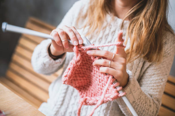 istock Close up on woman's hands knitting 1158804930