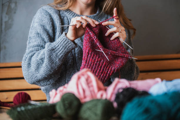 Close up on woman's hands knitting