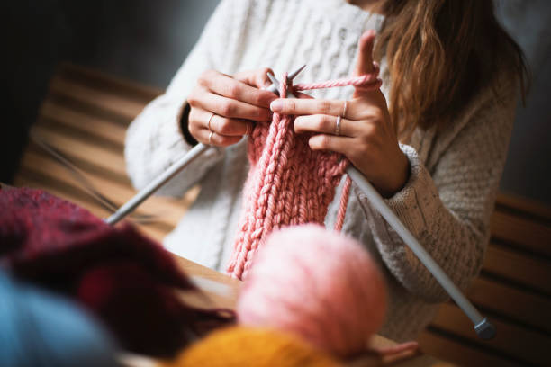 istock Close up on woman's hands knitting 1158804938
