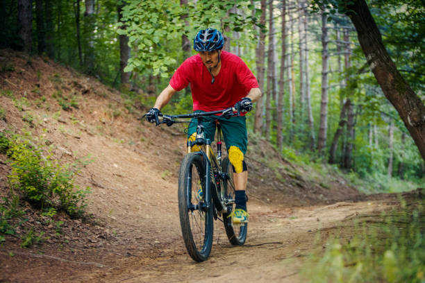 istock Mountain biker climbing in the woods 1158804948