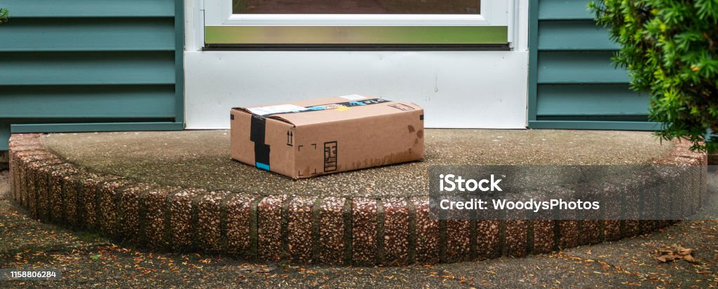 Package Left Out In The Rain Exposed On A Front Porch Stock Photo -  Download Image Now - iStock