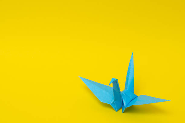 White origami photographed on blue background with shallow DOF.