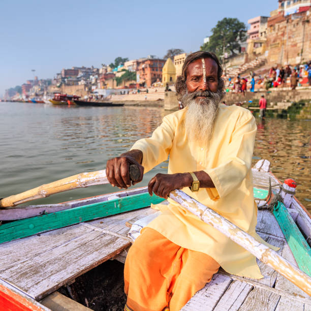 istock Sadhu rowing boat on the holy Ganges River in Varanasi 1158808484