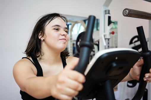 Teen girl with down syndrome exercise at gym