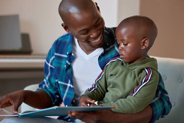 istock Happy father reading to child 1158810499