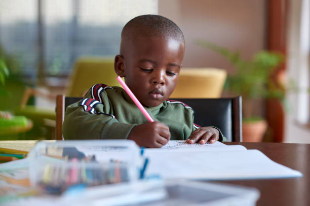 istock Young artistic boy drawing at home 1158810533