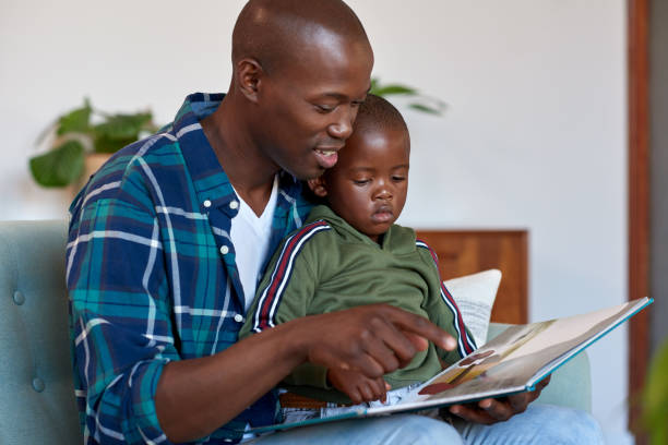istock Loving father reading stories to kid 1158810582